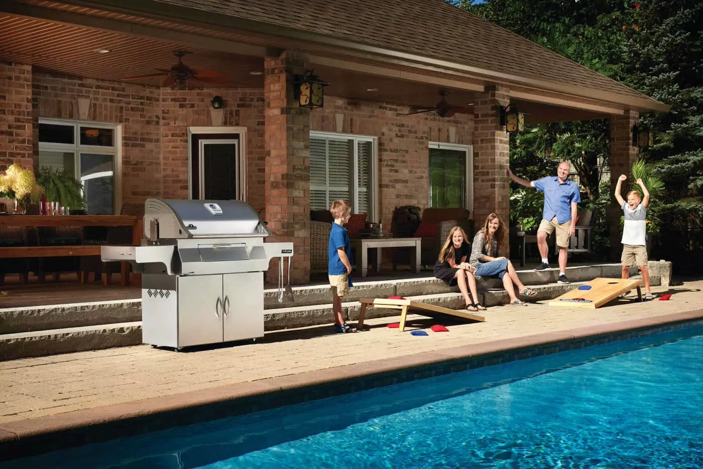 Napoleon Professional 605 Charcoal Grill being Enjoyed by Family